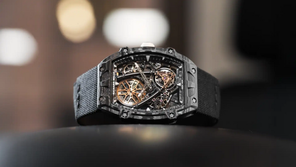 Luxury watch with intricate design on a dark surface